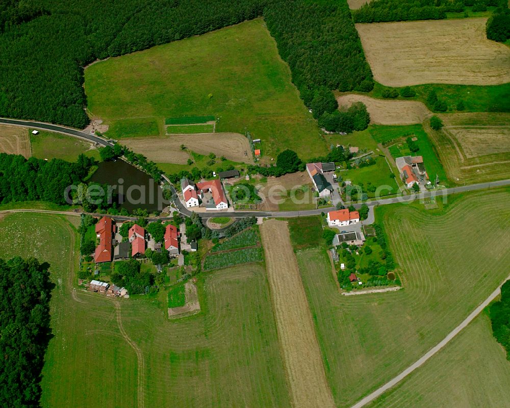 Thiendorf from above - Agricultural land and field boundaries surround the settlement area of the village in Thiendorf in the state Saxony, Germany