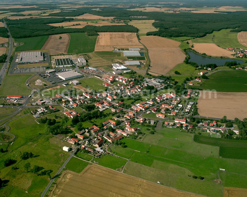 Thiendorf from the bird's eye view: Agricultural land and field boundaries surround the settlement area of the village in Thiendorf in the state Saxony, Germany