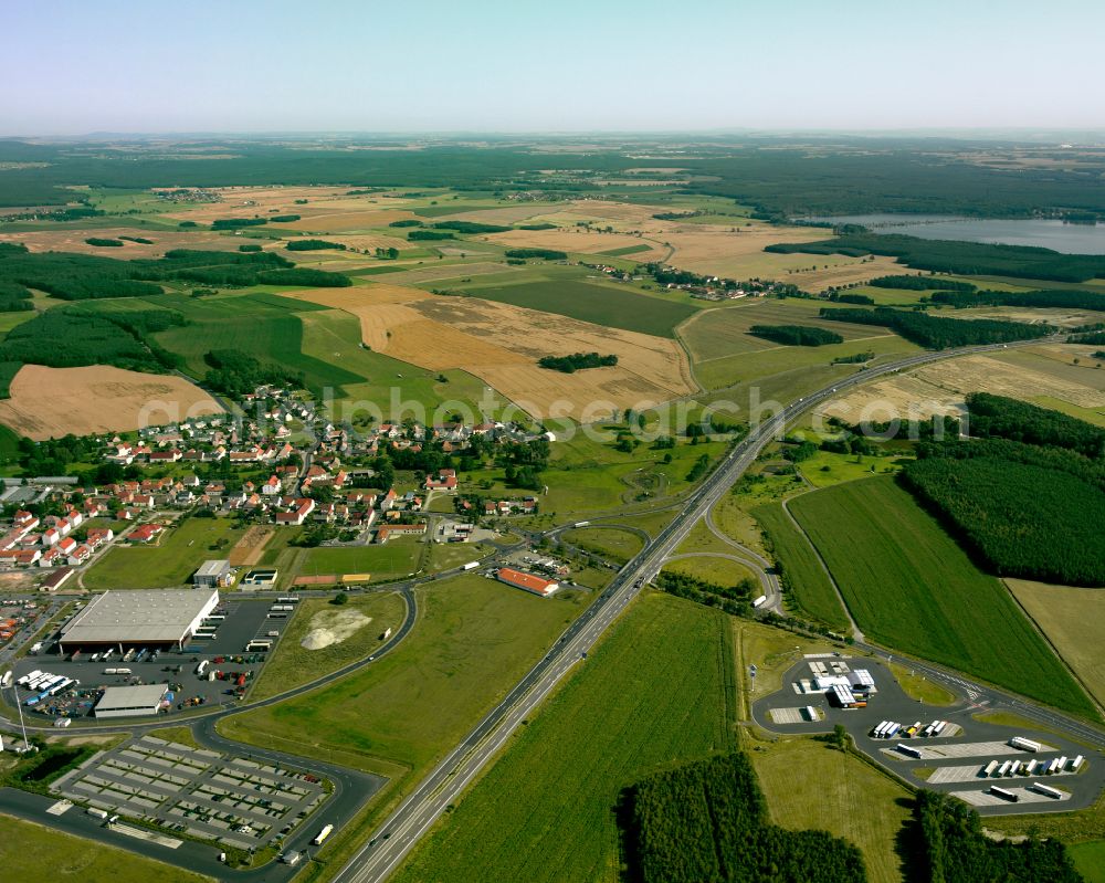 Thiendorf from above - Agricultural land and field boundaries surround the settlement area of the village in Thiendorf in the state Saxony, Germany