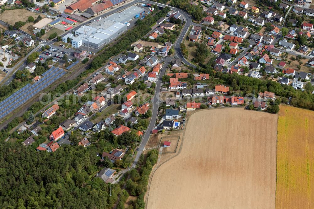 Thüngen from the bird's eye view: Agricultural land and field boundaries surround the settlement area of the village in Thüngen in the state Bavaria, Germany