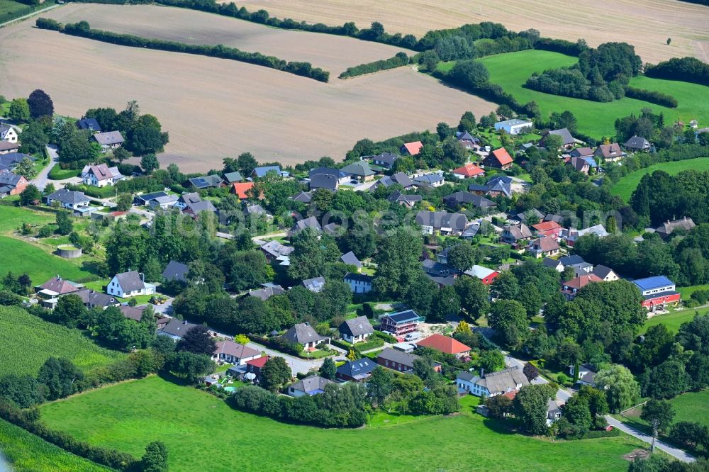 Thumby from above - Agricultural land and field boundaries surround the settlement area of the village in Thumby in the state Schleswig-Holstein, Germany