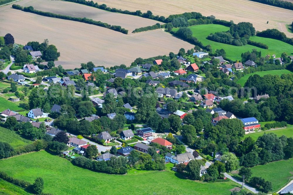 Thumby from the bird's eye view: Agricultural land and field boundaries surround the settlement area of the village in Thumby in the state Schleswig-Holstein, Germany