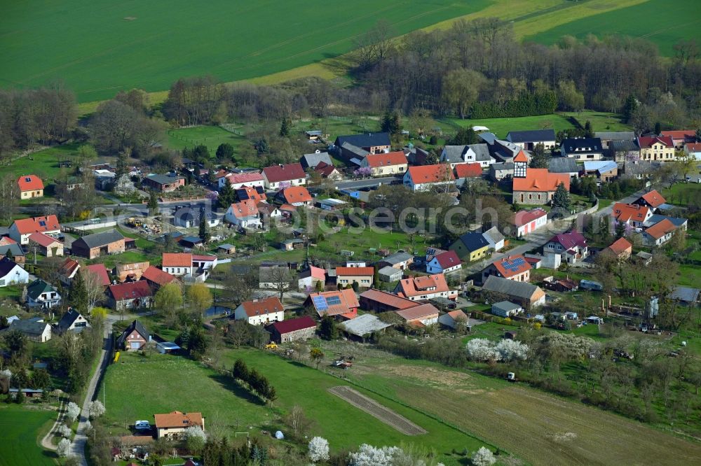 Tornow from the bird's eye view: Agricultural land and field boundaries surround the settlement area of the village in Tornow in the state Brandenburg, Germany