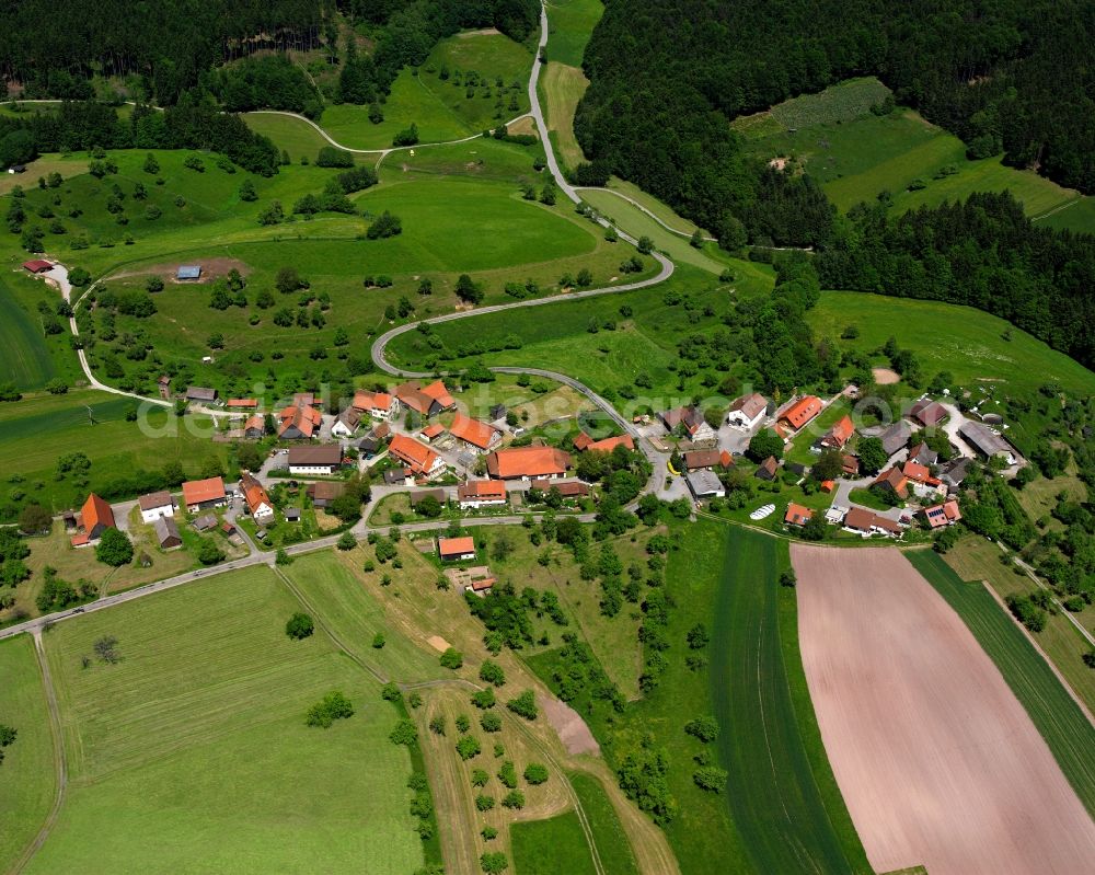 Trauzenbach from above - Agricultural land and field boundaries surround the settlement area of the village in Trauzenbach in the state Baden-Wuerttemberg, Germany