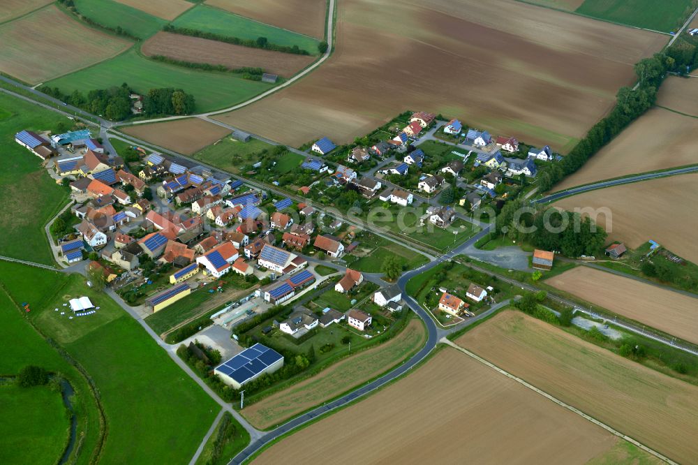 Treinfeld from the bird's eye view: Agricultural land and field boundaries surround the settlement area of the village in Treinfeld in the state Bavaria, Germany