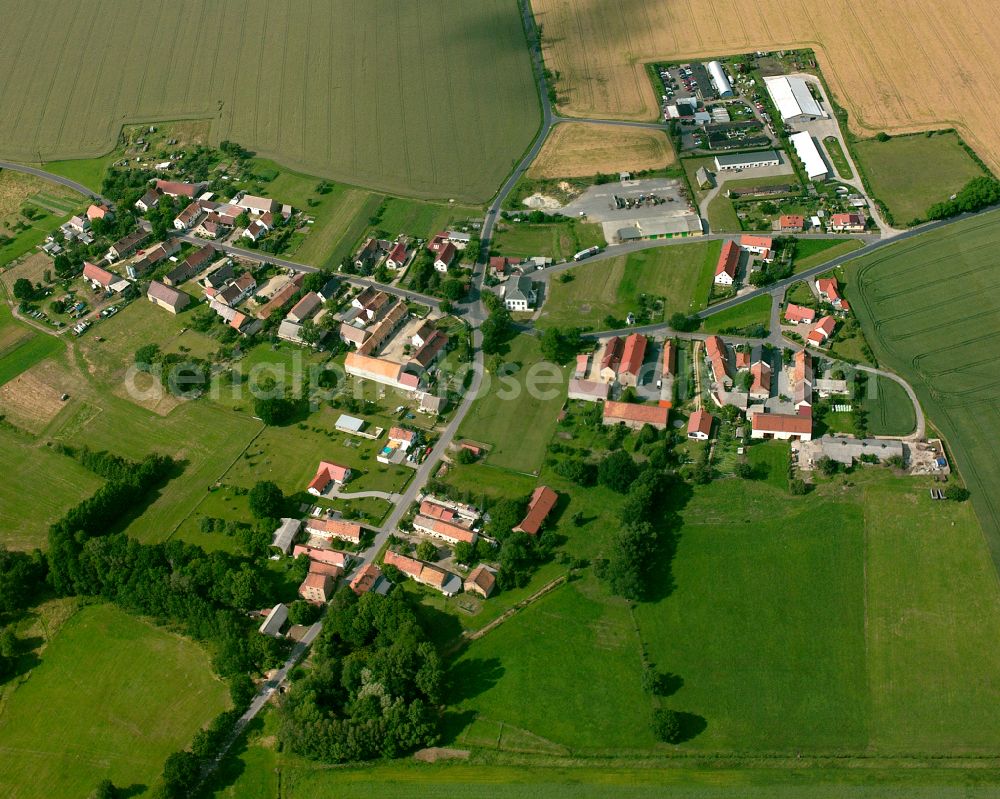 Aerial photograph Uebigau - Agricultural land and field boundaries surround the settlement area of the village in Uebigau in the state Saxony, Germany