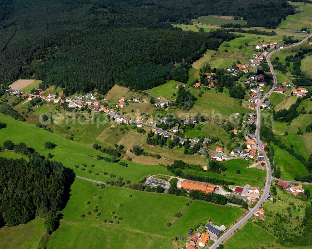 Aerial image Unter-Mossau - Agricultural land and field boundaries surround the settlement area of the village in Unter-Mossau in the state Hesse, Germany