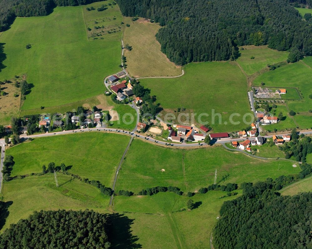 Aerial image Unter-Mossau - Agricultural land and field boundaries surround the settlement area of the village in Unter-Mossau in the state Hesse, Germany