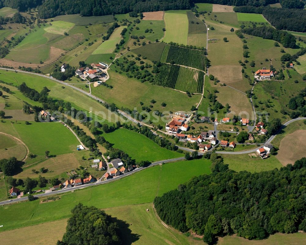 Aerial photograph Unter-Ostern - Agricultural land and field boundaries surround the settlement area of the village in Unter-Ostern in the state Hesse, Germany