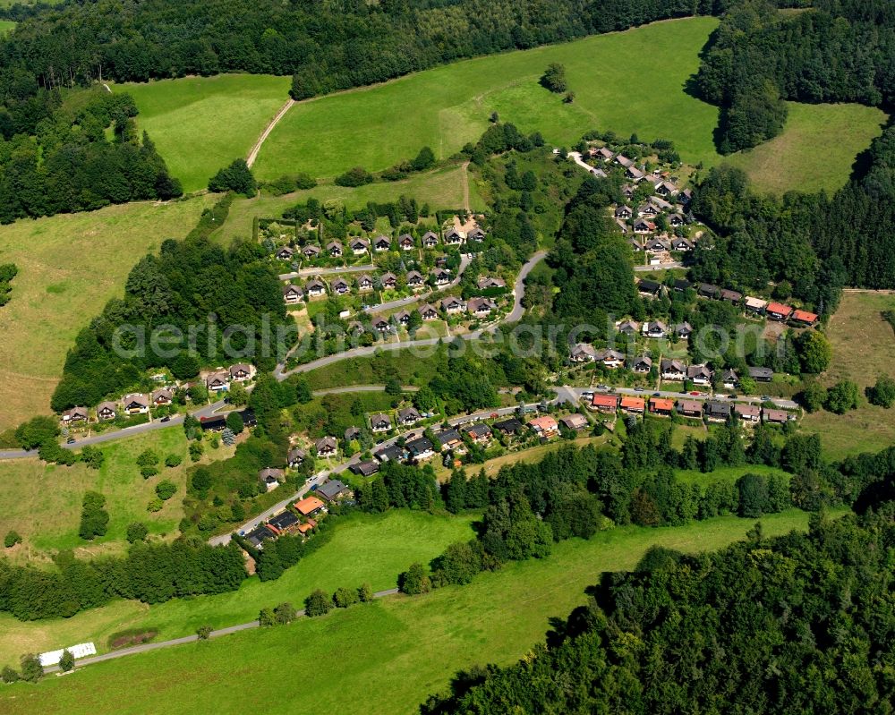 Unter-Ostern from above - Agricultural land and field boundaries surround the settlement area of the village in Unter-Ostern in the state Hesse, Germany