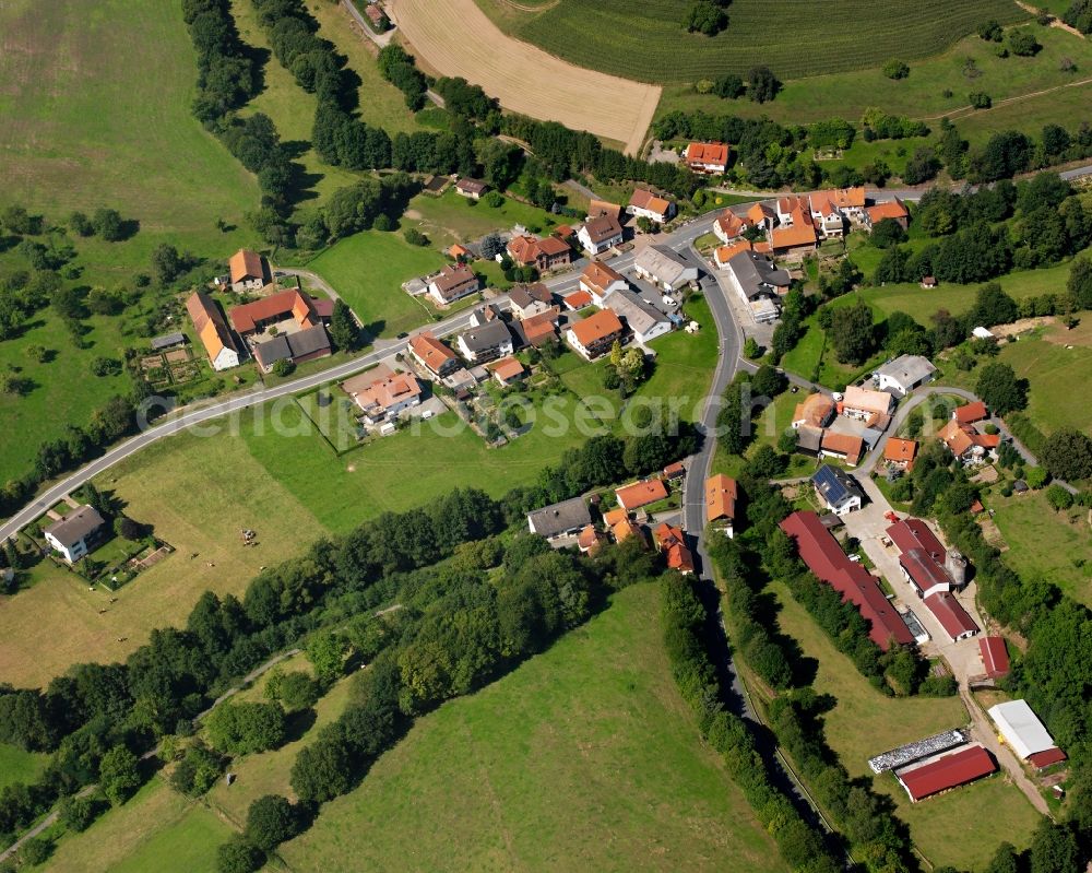 Aerial photograph Unter-Ostern - Agricultural land and field boundaries surround the settlement area of the village in Unter-Ostern in the state Hesse, Germany