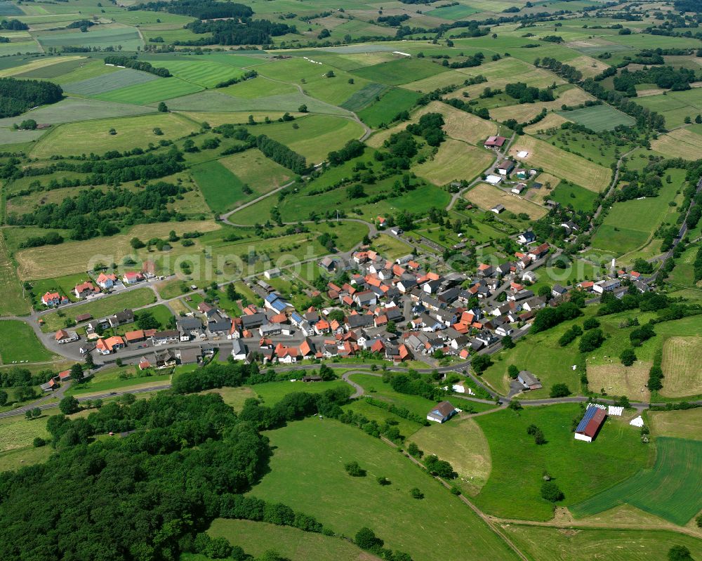 Unter-Seibertenrod from the bird's eye view: Agricultural land and field boundaries surround the settlement area of the village in Unter-Seibertenrod in the state Hesse, Germany