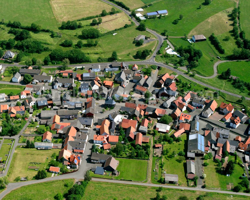 Unter-Seibertenrod from the bird's eye view: Agricultural land and field boundaries surround the settlement area of the village in Unter-Seibertenrod in the state Hesse, Germany