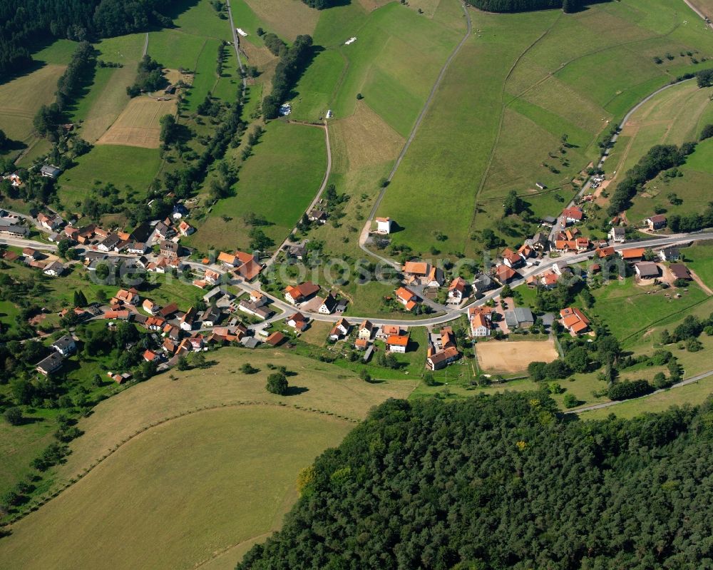 Unter-Sensbach from above - Agricultural land and field boundaries surround the settlement area of the village in Unter-Sensbach in the state Hesse, Germany