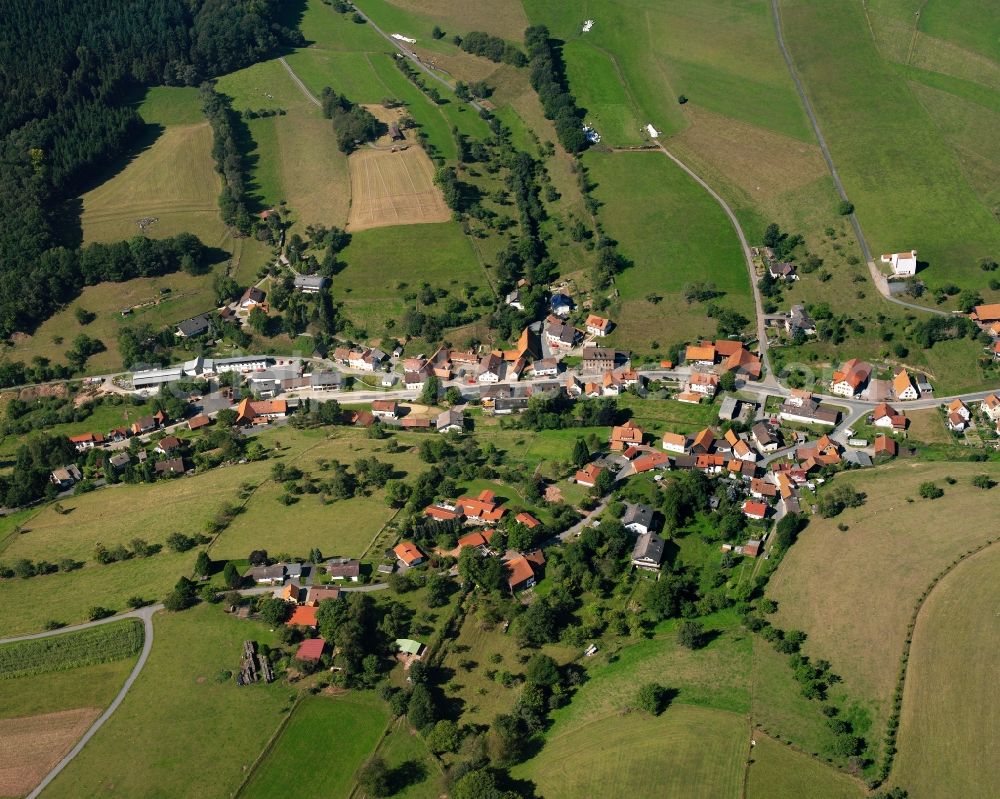 Unter-Sensbach from the bird's eye view: Agricultural land and field boundaries surround the settlement area of the village in Unter-Sensbach in the state Hesse, Germany