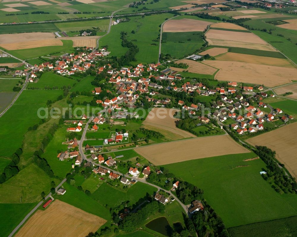 Unterampfrach from above - Agricultural land and field boundaries surround the settlement area of the village in Unterampfrach in the state Bavaria, Germany