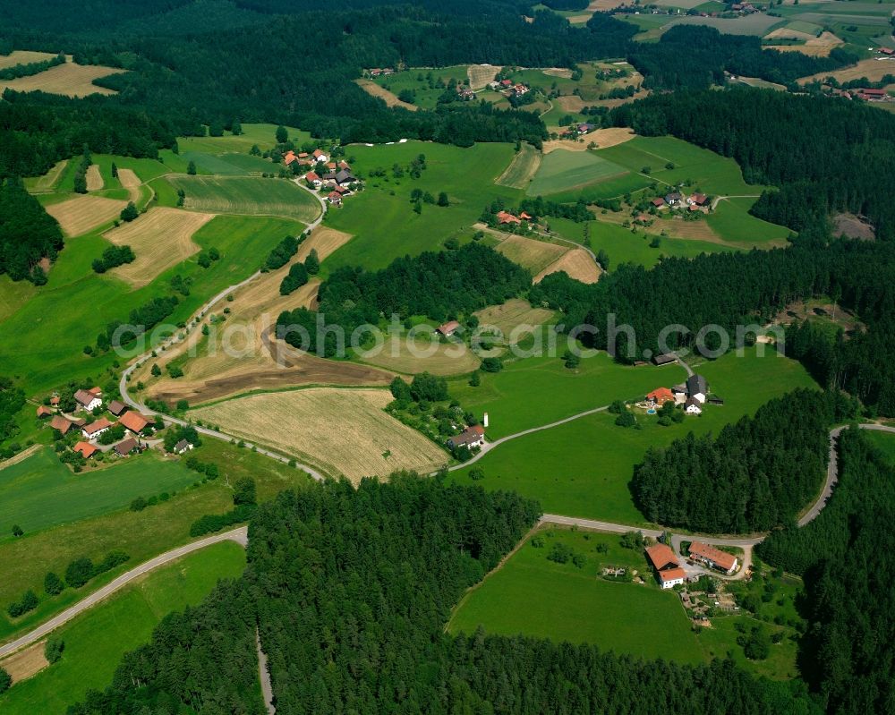 Unterholzen from above - Agricultural land and field boundaries surround the settlement area of the village in Unterholzen in the state Bavaria, Germany