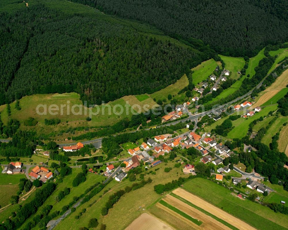 Unterneurode from the bird's eye view: Agricultural land and field boundaries surround the settlement area of the village in Unterneurode in the state Hesse, Germany