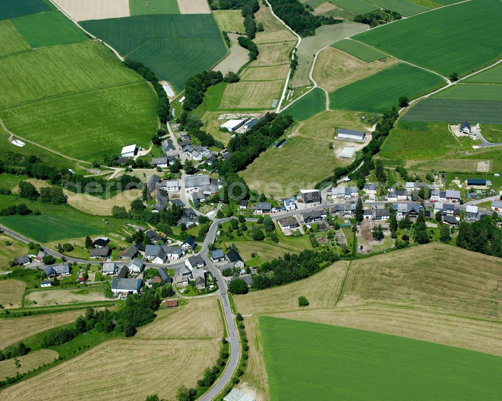 Unzenberg from above - Agricultural land and field boundaries surround the settlement area of the village in Unzenberg in the state Rhineland-Palatinate, Germany