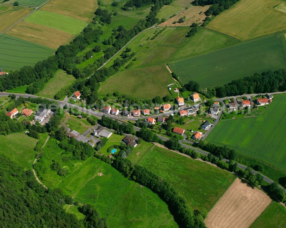 Aerial image Uschlag - Agricultural land and field boundaries surround the settlement area of the village in Uschlag in the state Lower Saxony, Germany