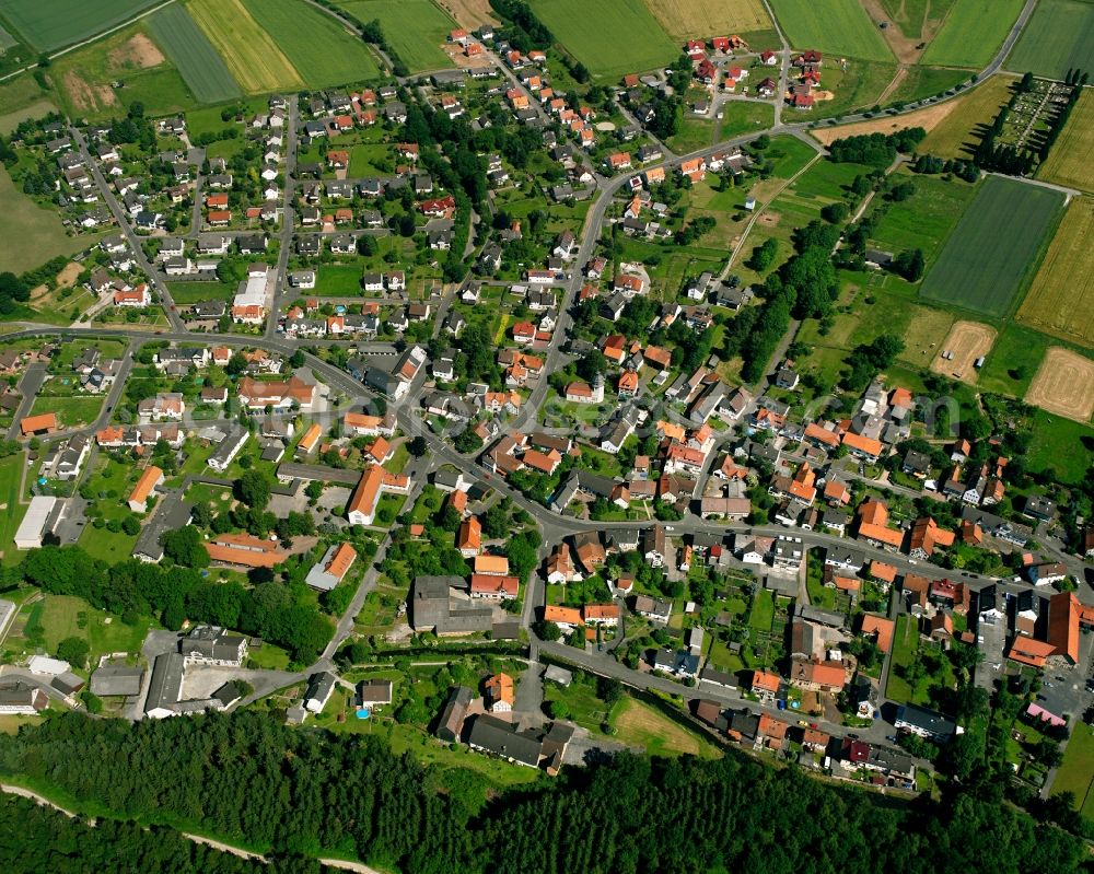 Uschlag from above - Agricultural land and field boundaries surround the settlement area of the village in Uschlag in the state Lower Saxony, Germany