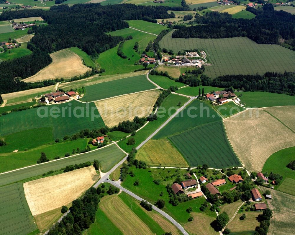 Uttendorf from the bird's eye view: Agricultural land and field boundaries surround the settlement area of the village in Uttendorf in the state Bavaria, Germany