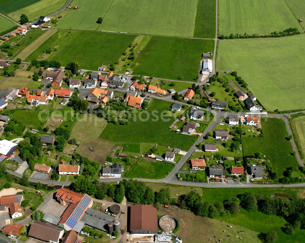 Aerial image Vadenrod - Agricultural land and field boundaries surround the settlement area of the village in Vadenrod in the state Hesse, Germany