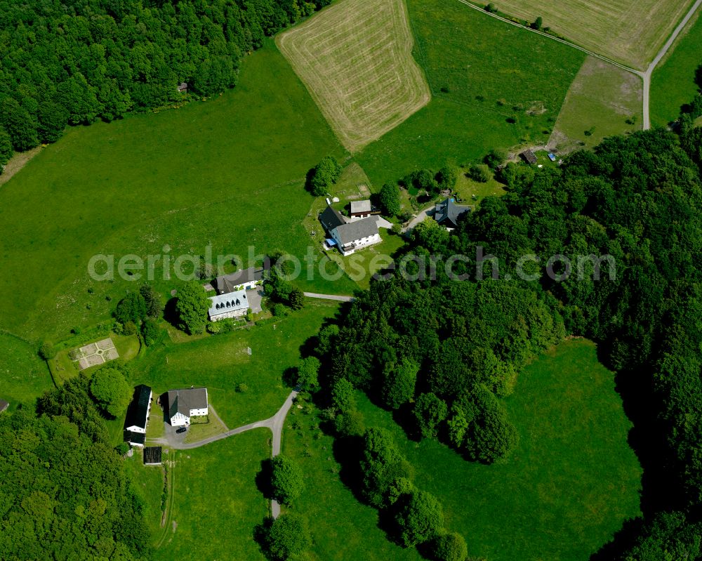 Valbert from the bird's eye view: Agricultural land and field boundaries surround the settlement area of the village in Valbert in the state North Rhine-Westphalia, Germany