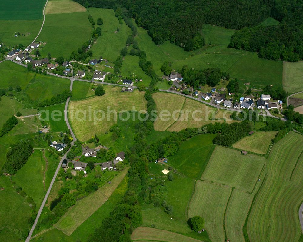 Valbert from above - Agricultural land and field boundaries surround the settlement area of the village in Valbert in the state North Rhine-Westphalia, Germany