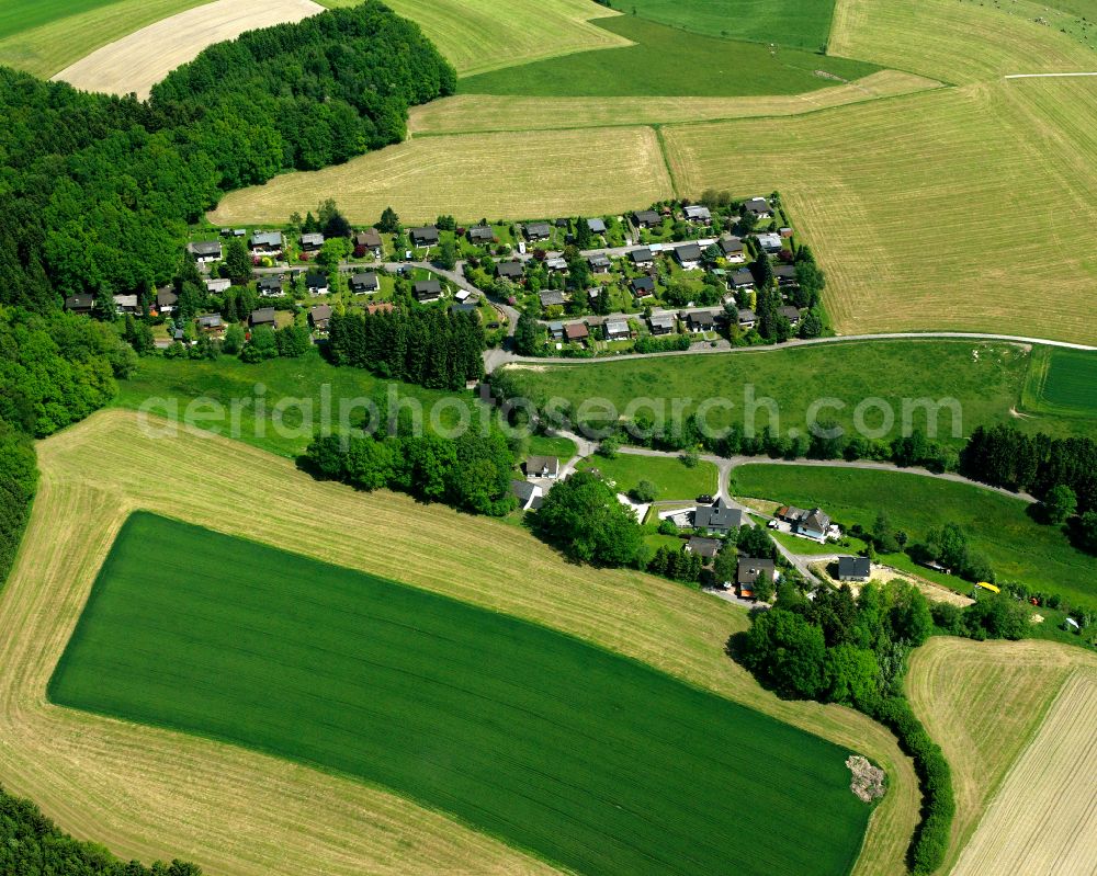 Valbert from above - Agricultural land and field boundaries surround the settlement area of the village in Valbert in the state North Rhine-Westphalia, Germany