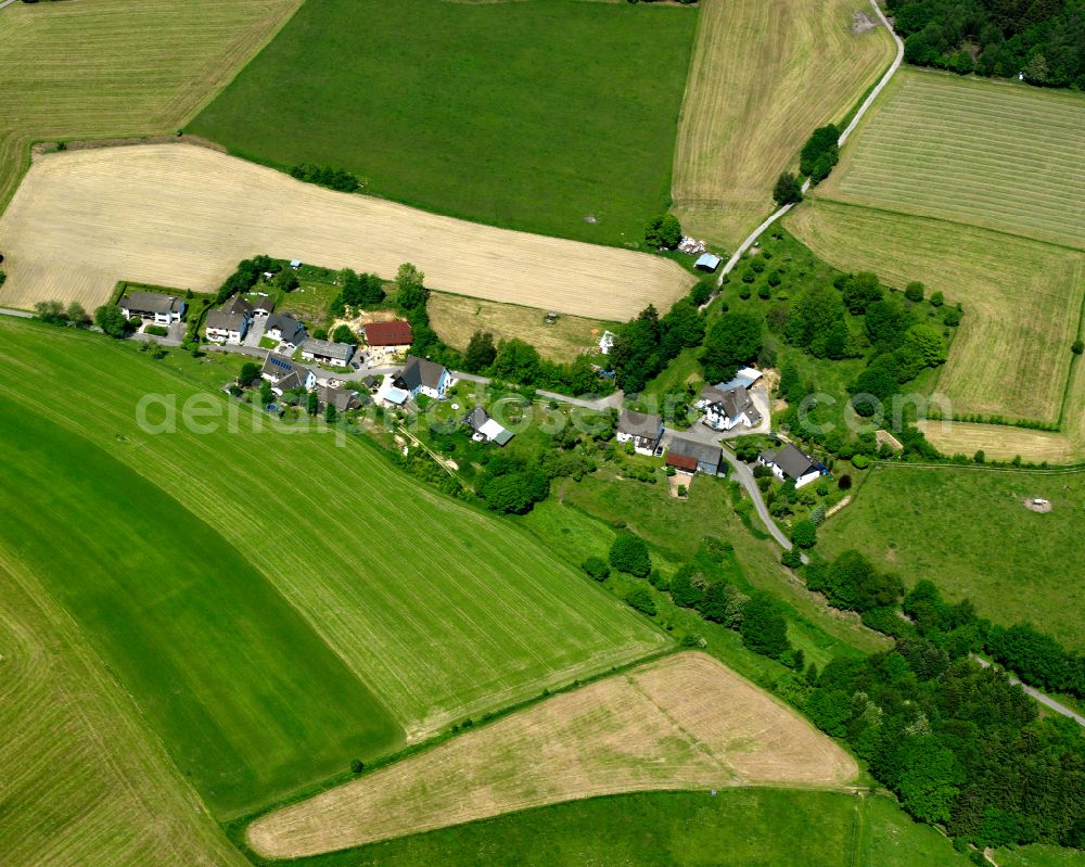 Valbert from the bird's eye view: Agricultural land and field boundaries surround the settlement area of the village in Valbert in the state North Rhine-Westphalia, Germany