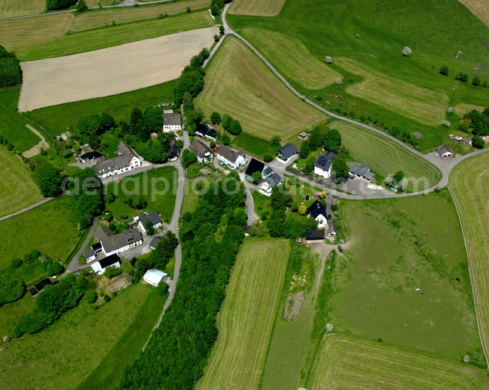 Valbert from the bird's eye view: Agricultural land and field boundaries surround the settlement area of the village in Valbert in the state North Rhine-Westphalia, Germany