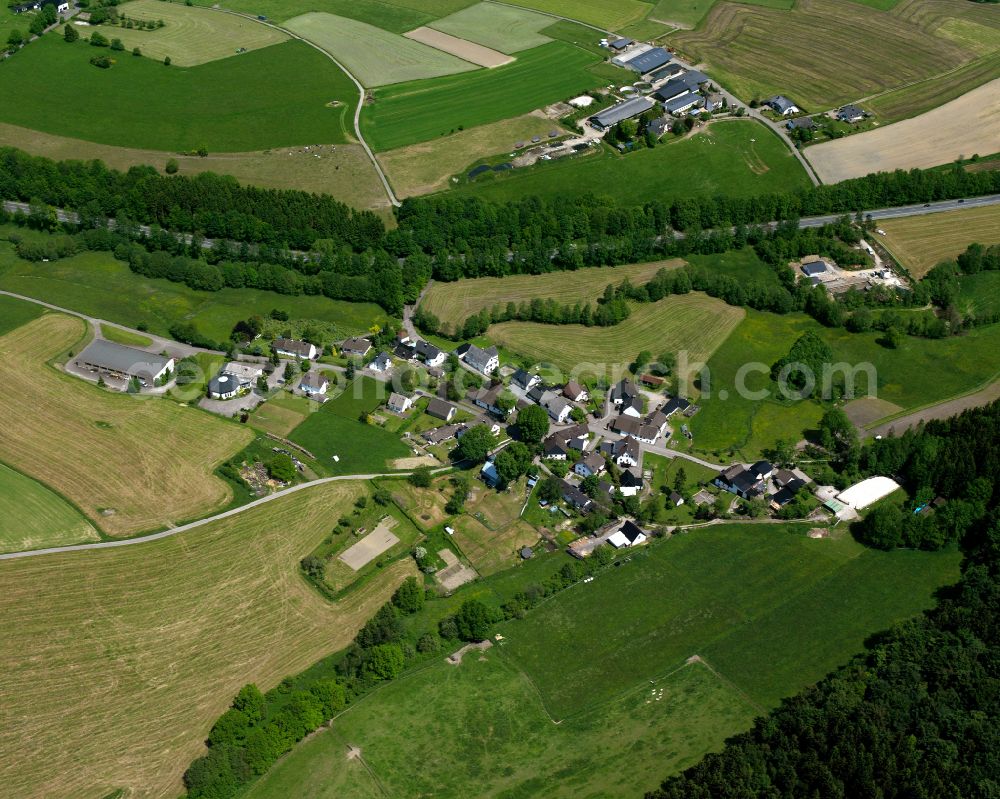 Valbert from above - Agricultural land and field boundaries surround the settlement area of the village in Valbert in the state North Rhine-Westphalia, Germany