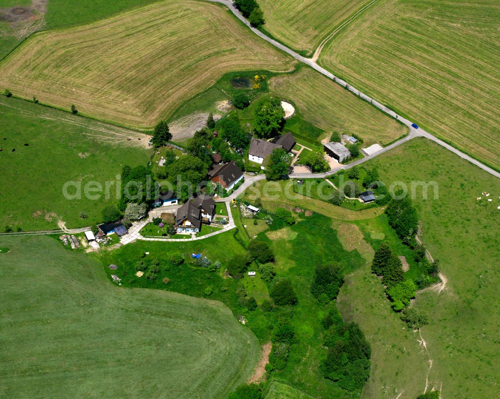 Valbert from the bird's eye view: Agricultural land and field boundaries surround the settlement area of the village in Valbert in the state North Rhine-Westphalia, Germany