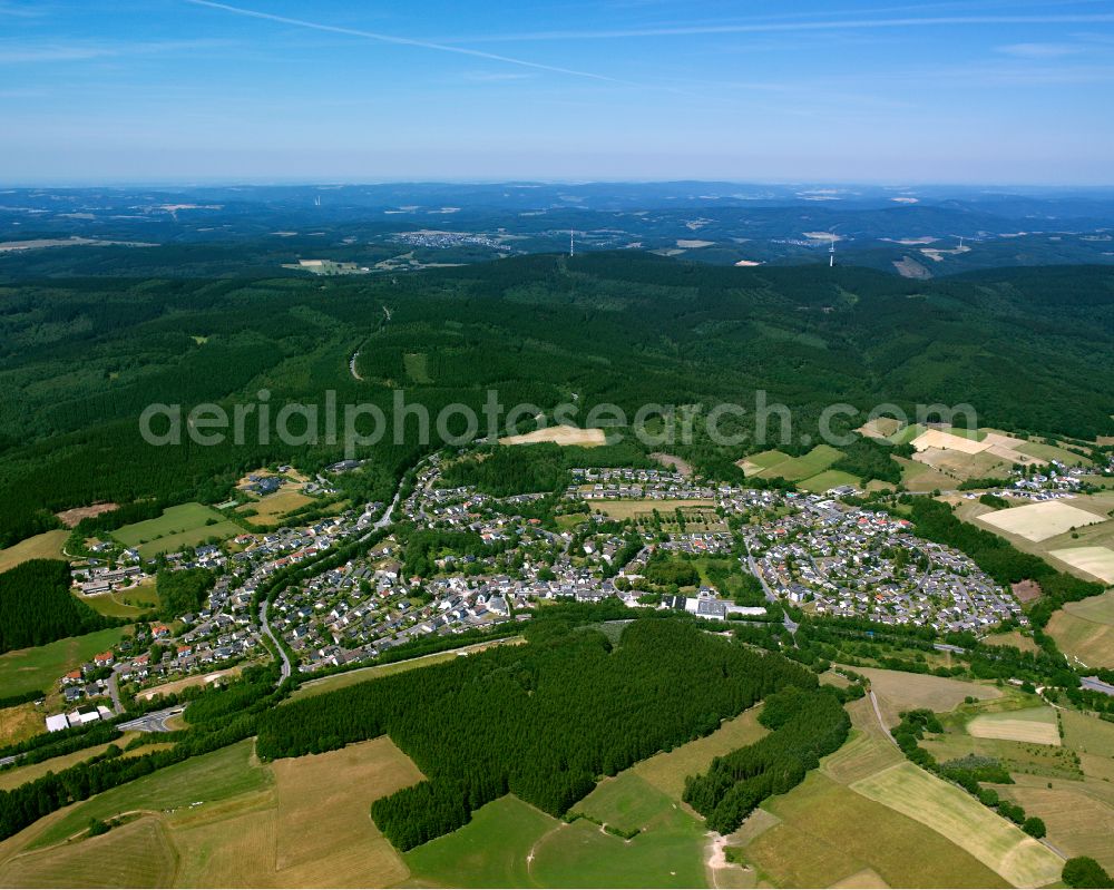 Valbert from the bird's eye view: Agricultural land and field boundaries surround the settlement area of the village in Valbert in the state North Rhine-Westphalia, Germany