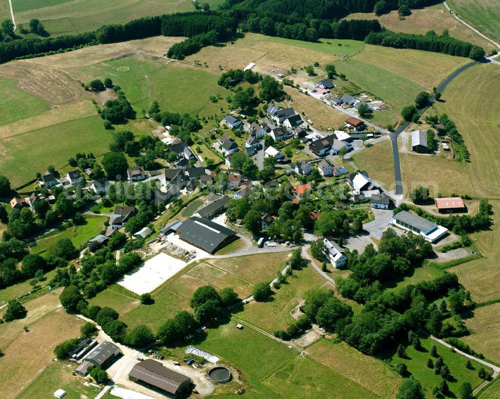 Valbert from the bird's eye view: Agricultural land and field boundaries surround the settlement area of the village in Valbert in the state North Rhine-Westphalia, Germany