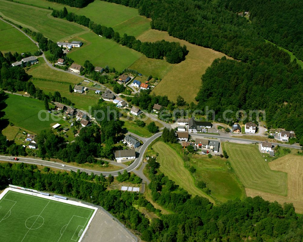 Valbert from the bird's eye view: Agricultural land and field boundaries surround the settlement area of the village in Valbert in the state North Rhine-Westphalia, Germany