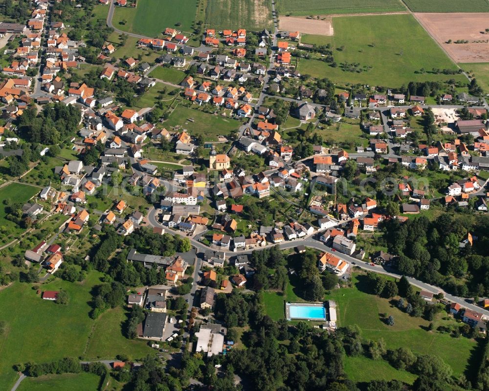 Vielbrunn from above - Agricultural land and field boundaries surround the settlement area of the village in Vielbrunn in the state Hesse, Germany