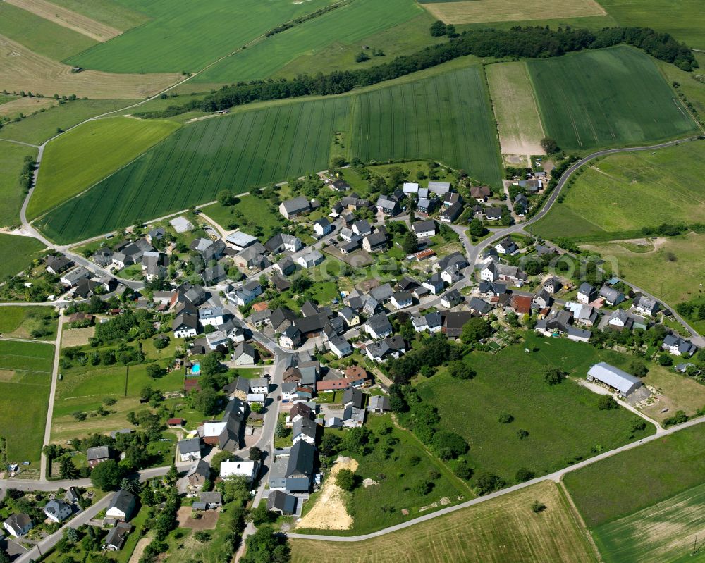 Völkenroth from the bird's eye view: Agricultural land and field boundaries surround the settlement area of the village in Völkenroth in the state Rhineland-Palatinate, Germany