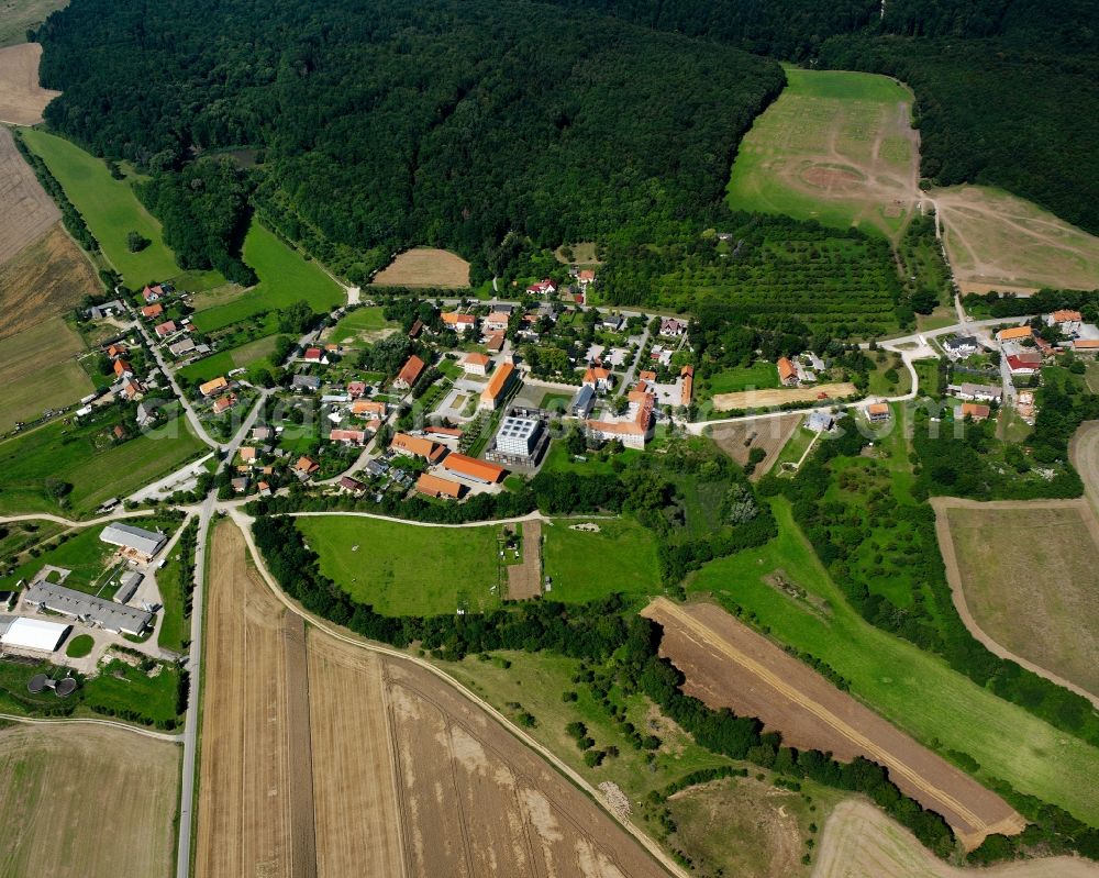 Volkenroda from the bird's eye view: Agricultural land and field boundaries surround the settlement area of the village in Volkenroda in the state Thuringia, Germany