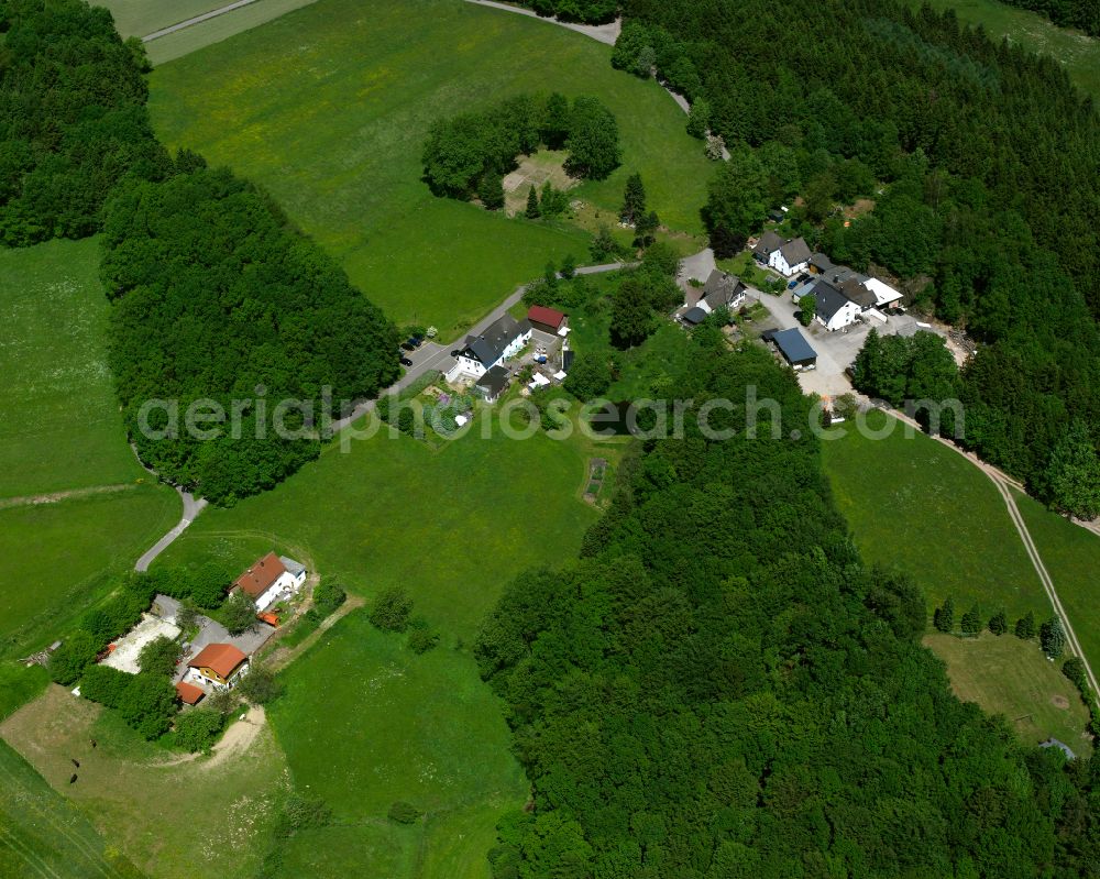 Vollme from above - Agricultural land and field boundaries surround the settlement area of the village in Vollme in the state North Rhine-Westphalia, Germany