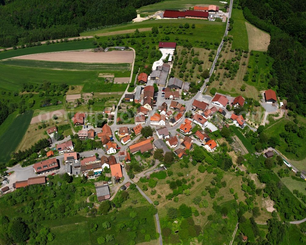 Vorderbüchelberg from the bird's eye view: Agricultural land and field boundaries surround the settlement area of the village in Vorderbüchelberg in the state Baden-Wuerttemberg, Germany