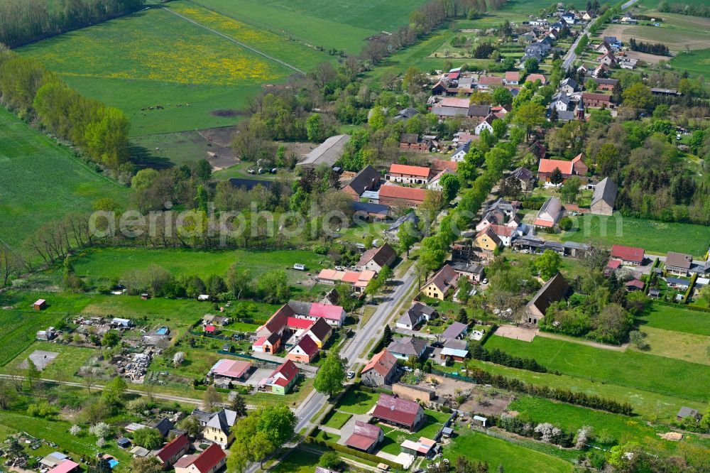 Walchow from above - Agricultural land and field boundaries surround the settlement area of the village in Walchow in the state Brandenburg, Germany