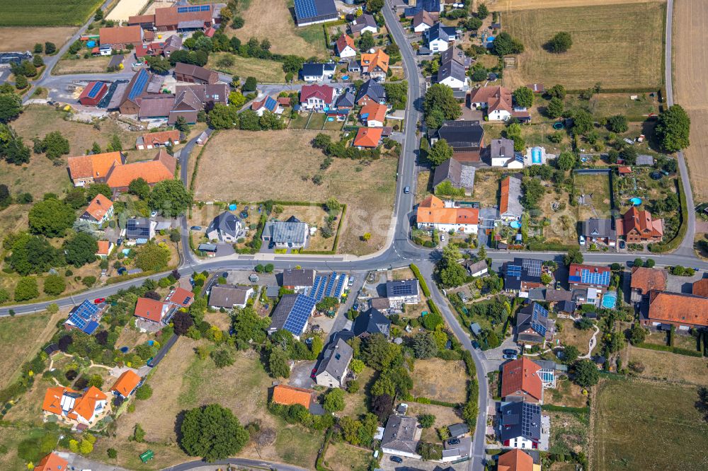 Wambeln from the bird's eye view: Agricultural land and field boundaries surround the settlement area of the village in Wambeln in the state North Rhine-Westphalia, Germany