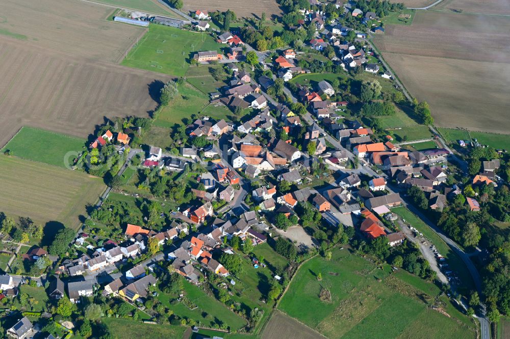 Wangelnstedt from the bird's eye view: Agricultural land and field boundaries surround the settlement area of the village in Wangelnstedt in the state Lower Saxony, Germany