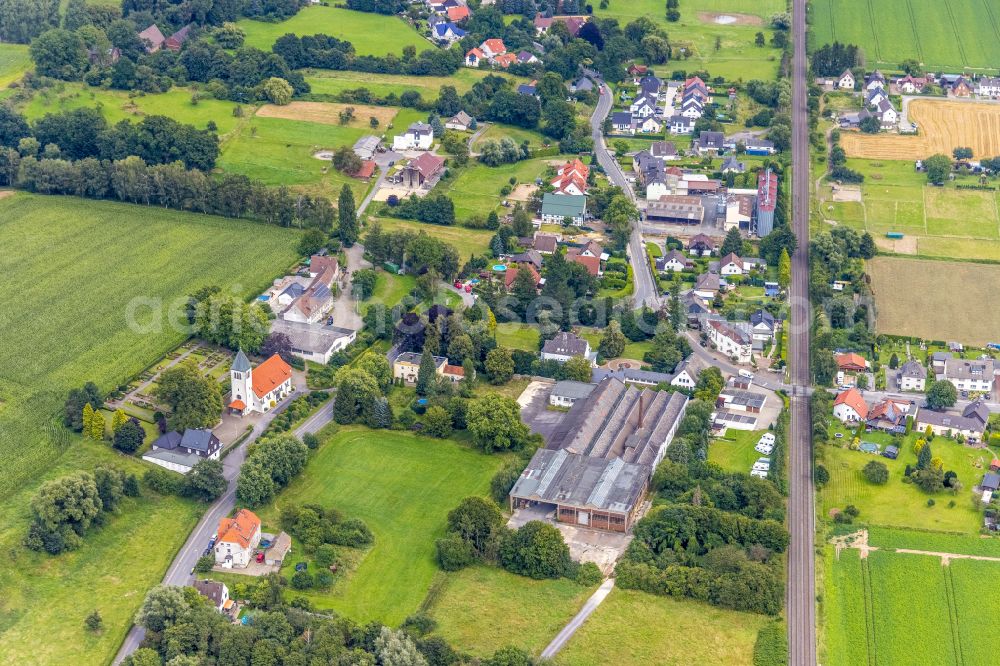 Warmen from above - Agricultural land and field boundaries surround the settlement area of the village in Warmen in the state North Rhine-Westphalia, Germany