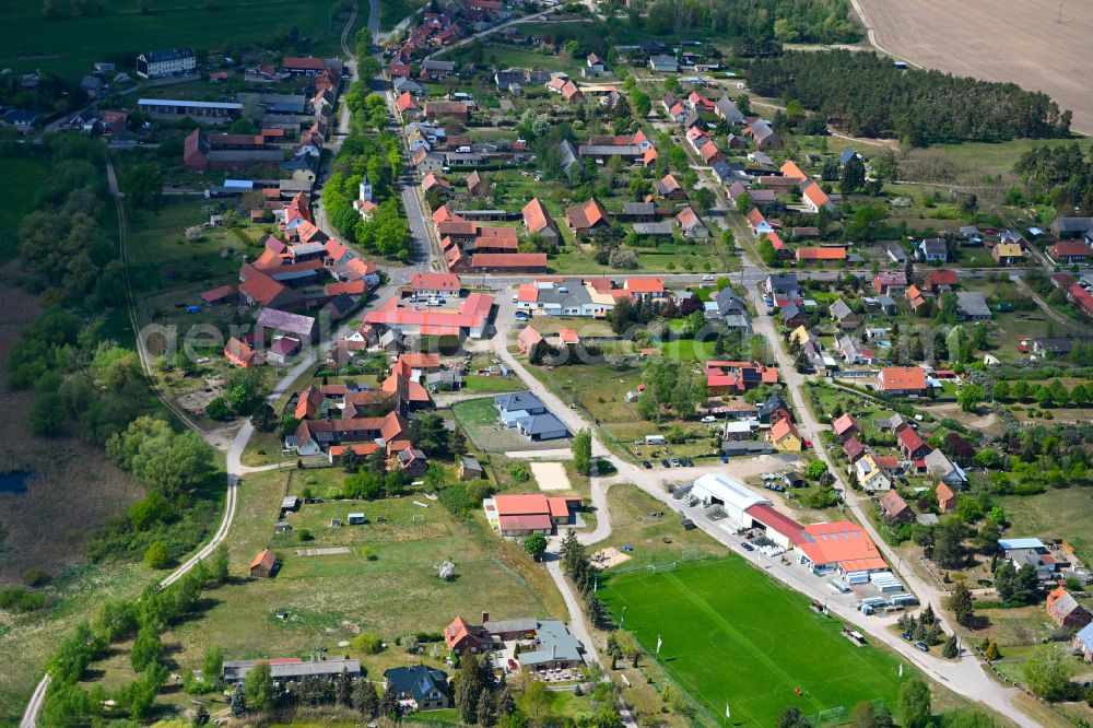 Warnau from above - Agricultural land and field boundaries surround the settlement area of the village in Warnau in the state Saxony-Anhalt, Germany