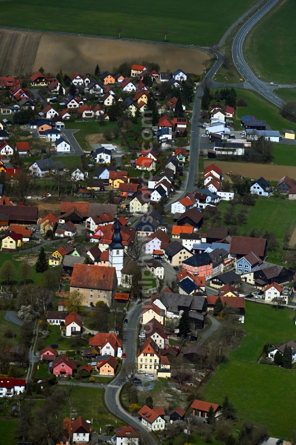 Wartenfels from the bird's eye view: Agricultural land and field boundaries surround the settlement area of the village in Wartenfels in the state Bavaria, Germany