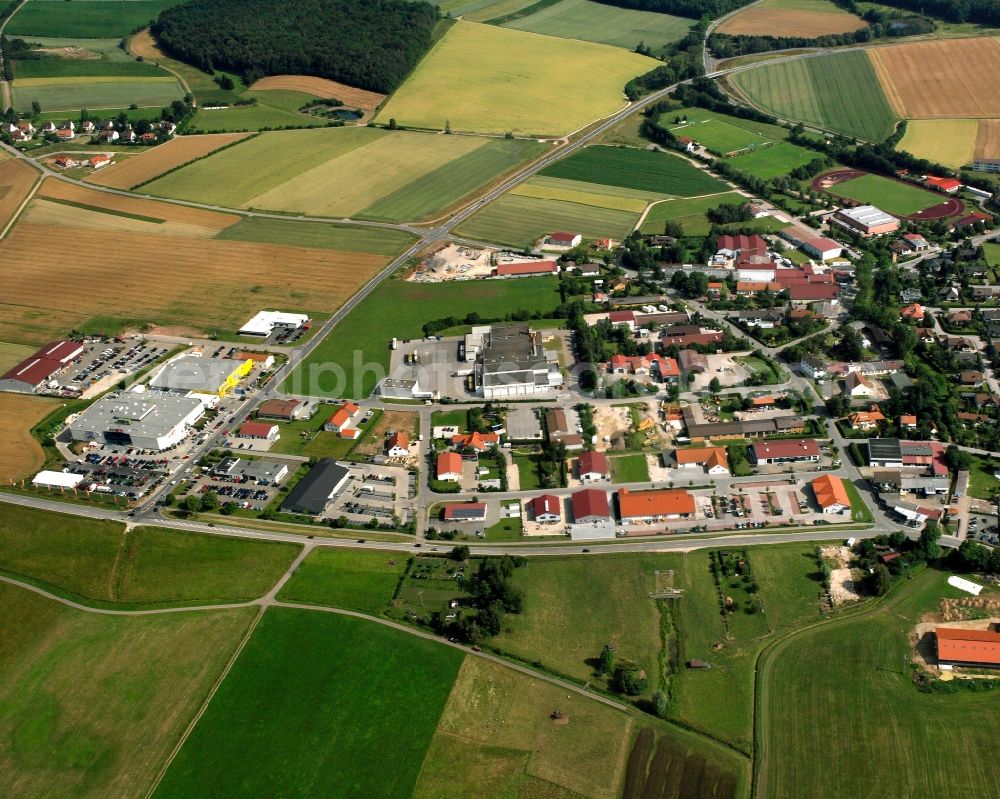 Wassertrüdingen from the bird's eye view: Agricultural land and field boundaries surround the settlement area of the village in Wassertrüdingen in the state Bavaria, Germany