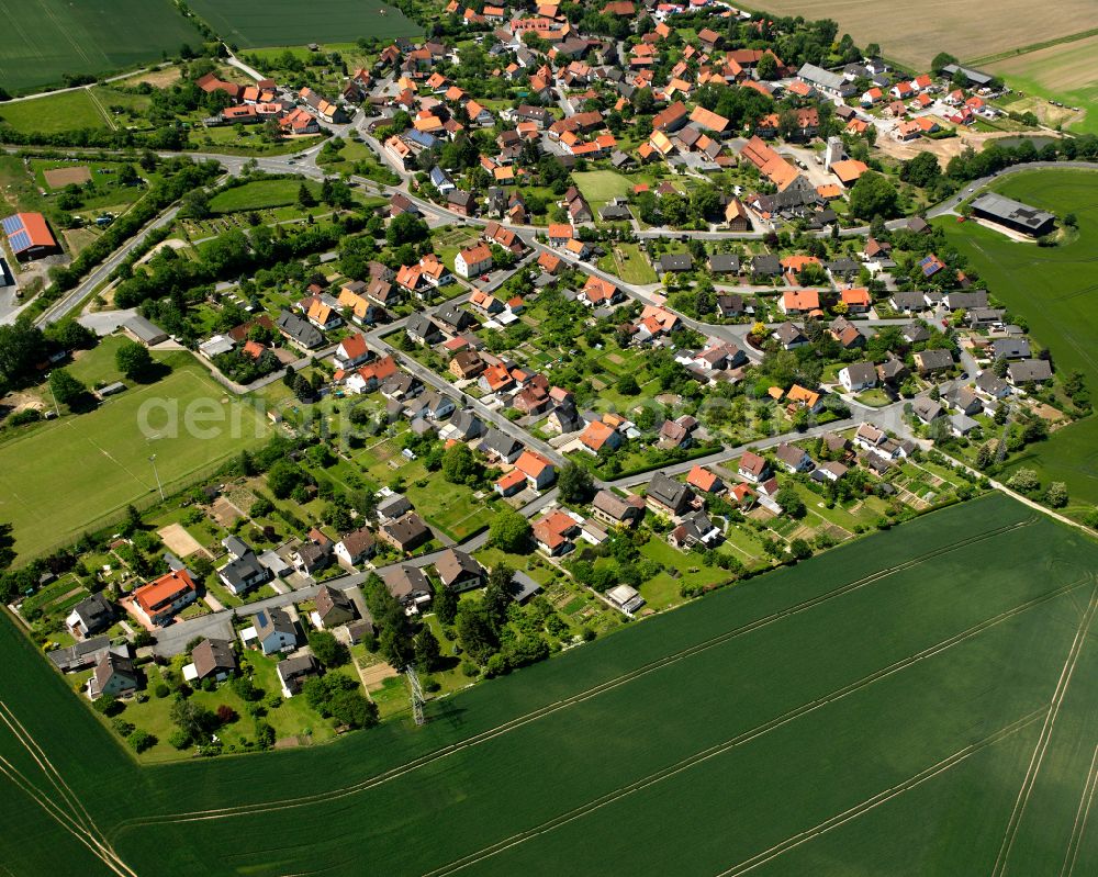 Weddingen from the bird's eye view: Agricultural land and field boundaries surround the settlement area of the village in Weddingen in the state Lower Saxony, Germany